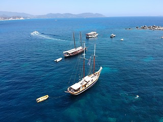 Image showing Aerial boat, sailing in Greece and summer sun on ocean holiday, relax in freedom and nature. Yacht vacation, travel and tropical cruise on sea adventure tour to Greek island on blue sky and water.