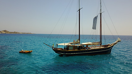 Image showing Yacht, sailing in Greece and summer on ocean holiday, relax in freedom and peace in nature on blue water. Boat vacation, travel in sun and tropical cruise on sea adventure to with island beach fun.