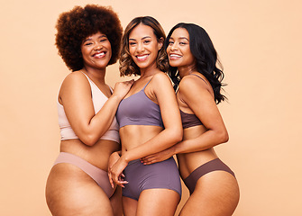 Image showing Diversity, body positivity and portrait of women with smile, self love and solidarity in studio together. Happiness, group of people on beige background with underwear, skincare and cosmetic equality