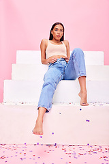 Image showing Woman, confetti and steps portrait with relax, style and fashion with celebration sparkle. Studio, pink background and female model with party, event and birthday decoration with gen z confidence