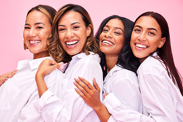 Image showing Women, friends smile and portrait in studio with natural beauty, diversity and white shirt with laugh. Pink background, bonding and young female group together with inclusion, happy hug and wellness