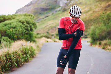 Image showing Man, cyclist and arm injury in fitness accident, emergency or broken bone on mountain road in nature. Male person or athlete with sore pain, ache or inflammation on joint in sports fall or cycling