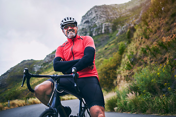 Image showing Portrait, cycling and arms crossed with man in nature for sports, training and challenge. Exercise, workout and health with mature person on bike in mountains for energy, freedom and performance