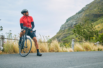 Image showing Fitness, cycling and relax with man on bike in nature for sports, training and challenge. Exercise, workout and health with mature person on bicycle in mountains for energy, freedom and performance