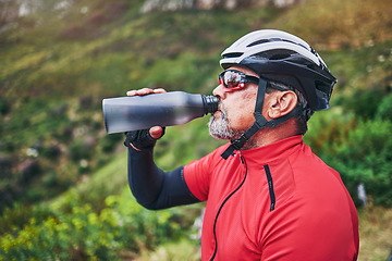 Image showing Man, cyclist and drinking water on mountain in fitness, diet or natural nutrition in rest or break after cycling exercise. Thirsty male person with mineral drink for sustainability in cardio training