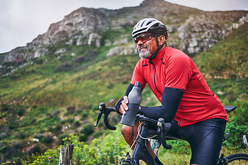 Image showing Fitness, cycling and water with man on bike in nature for sports, training and challenge. Exercise, workout and health with mature person on bicycle in mountains for energy, freedom and performance