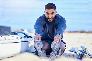 Image showing Portrait, beach and man stretching legs to start workout, training and kayak exercise for sports. Happy, athlete and person warm up at ocean to prepare for fitness, healthy body and flexible outdoor