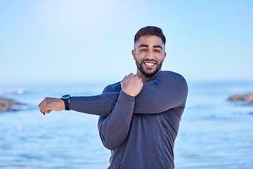 Image showing Beach portrait, exercise and happy man stretching arm for outdoor freedom, sports workout or start routine. Blue sky, natural sea water and Indian person doing relax training warm up on nature island