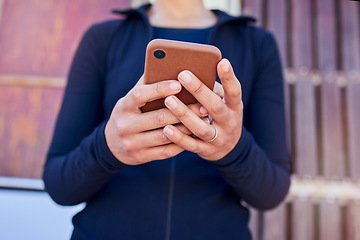 Image showing Hands, phone and woman outdoor for location, search or internet, map or travel guide with text in city street. Smartphone, app and lady online for social media, notification or web chat while waiting