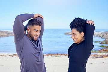 Image showing Beach, exercise and happy couple of friends stretching for fitness, teamwork and start workout performance, routine or arm care. Sea, eye contact and team partner doing warm up, wellness or training