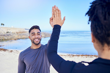 Image showing Fitness, couple and high five on the beach for exercise, outdoor workout or training for water sports, teamwork and healthy cardio. Happy, man and woman athlete with motivation or support in winning