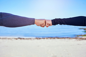 Image showing Fitness, couple and fist bump on the beach for exercise, outdoor workout or celebration in water sports, teamwork and cardio. People, hands and sign of collaboration together in support or success