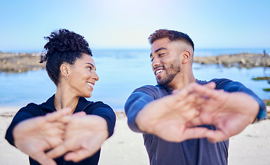 Image showing Beach workout, stretching hands and happy couple of friends smile for team exercise, sports or athlete fitness. Summer wellness, eye contact and nature people training, active and start warm up