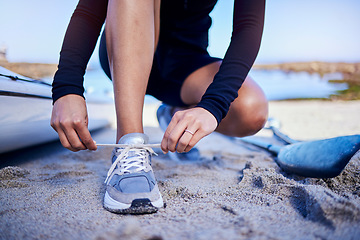 Image showing Hands tie shoes, beach and athlete start workout, training and kayak exercise outdoor. Sand, person and tying sneakers at ocean to prepare in fitness, sports and healthy body for wellness in summer.