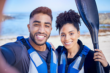 Image showing Selfie, kayak and couple with a smile, beach and summer vacation with memory, post and social media. Portrait, people and man with woman, water sports and picture with ocean, training and holiday