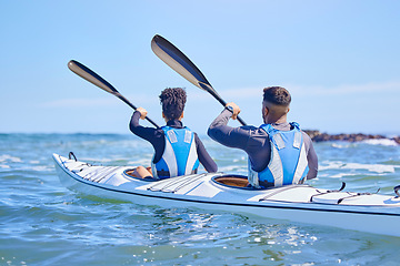 Image showing Water, man and woman in kayak and sports on lake, beach or river for exercise together on vacation. Ocean holiday, adventure and fitness, couple in canoe for training workout in teamwork on blue sky.