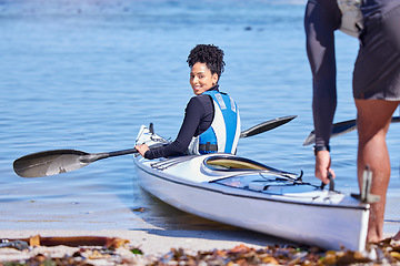 Image showing Water, portrait of woman in kayak and getting ready at lake, beach or river for exercise with smile. Ocean holiday, adventure and fitness, happy couple in canoe for training workout for sports at sea