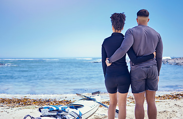 Image showing Couple, kayak and outdoor for travel adventure at a beach with a partner for teamwork. Behind a man and woman with a canoe for water sports, banner space in sky and vacation or freedom in nature