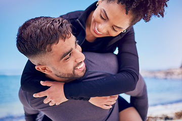 Image showing Piggyback, love and fitness couple at a beach for training, bond and morning workout in nature. Sports, workout and happy man with woman at the ocean for wellness, freedom and exercise celebration