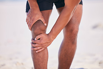 Image showing Hands, knee pain and athlete at beach, accident and fitness exercise in sport workout outdoor. Legs, injury and arthritis of man, muscle problem and fibromyalgia in medical emergency for osteoporosis