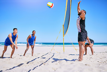 Image showing Blue sky beach, volleyball and sports people playing competition, outdoor match or practice for group tournament. Opponent, game net and team player workout, training or exercise for athlete teamwork