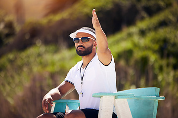 Image showing Summer, sports and a volleyball referee on the beach in a chair for authority, rules or regulations during a game. Health, professional or competition with a man refereeing a match outdoor in the day