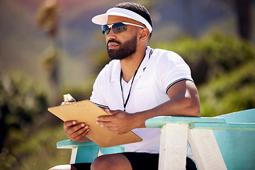 Image showing Summer, clipboard and a volleyball referee on the beach in a chair for authority, rules or regulations during a game. Health, documents or competition with a man refereeing a match in the day