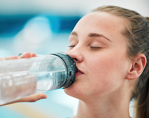 Image showing Swimmer woman, drinking water bottle or thinking for fitness, health or wellness for sport career. Athlete girl, hydration and vision by swimming pool at training, exercise or workout for performance