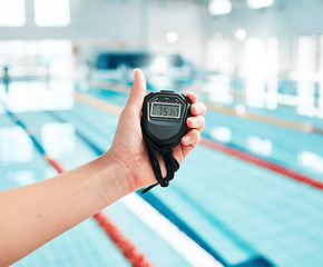 Image showing Person, hand and stopwatch by pool in swimming, race or sports training in fitness, exercise or workout. Closeup of swim coach holding timer for monitoring performance, speed or setting challenge