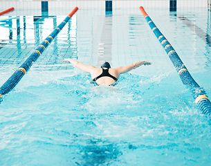 Image showing Sports, swimming pool and woman athlete training for a race, competition or tournament. Fitness, workout and back of female swimmer practicing a cardio water skill for exercise, speed or endurance.