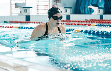 Image showing Swimming, athlete and sports woman in water for training, action and performance in competition, race and challenge. Pool, swimmer and underwater goggles for fitness, triathlon contest and exercise