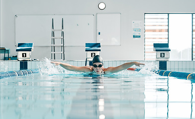 Image showing Pool, water splash and sports person swimming, training and practice challenge, fitness or workout routine in gym. Swimmer stroke, commitment and athlete cardio, race competition or match action