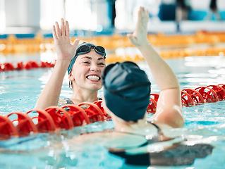 Image showing Fitness, swimmer and women with high five, celebration and achievement with workout, wellness and winning. Exercise, winner or champion in a pool, celebration or support with success, sports or smile