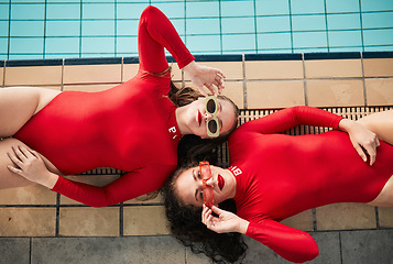 Image showing Sunglasses, swimwear and fashion women or friends in red bodysuit at indoor swimming pool. Portrait above young people relax with sports aesthetic, style and art or luxury in designer clothes