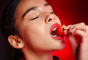 Image showing Face, eating and woman with red strawberry for fruit detox, health wellness goals or nutritionist diet. Lipstick makeup, erotic. beauty and sexy model girl with food product, skincare and cosmetics