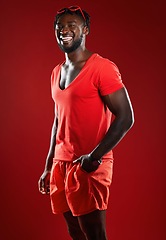 Image showing Black man, studio portrait and sport clothes with smile, sunglasses or happiness by red background. Model, man and happy with summer fashion, beauty and sports style for health, self care or wellness