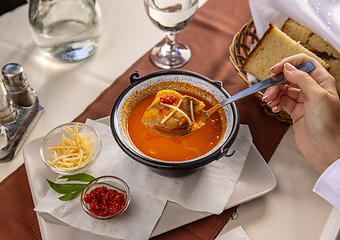 Image showing Fresh fish soup in small cauldron