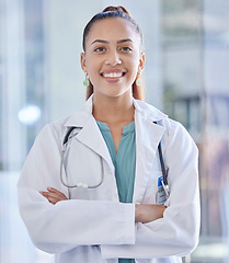 Image showing Doctor, woman and portrait with healthcare and happy medical professional in hospital against blurred background. Health, career and female in medicine with success and smile for cardio health care