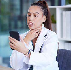 Image showing Phone, video call and doctor doing a consultation online for healthcare in her office at the hospital. Communication, technology and female medical worker consulting on a cellphone in medicare clinic