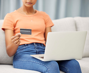 Image showing Black woman on sofa, laptop and credit card for finance, budget and check investments in lounge. Computer, female and girl in living room, online banking and transactions for payments and ecommerce