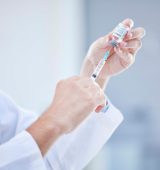 Image showing Hands, covid and doctor with vaccine syringe for healthcare, wellness and virus immunity. Corona, injection and medical professional holding needle for vaccination and covid 19 prevention in hospital