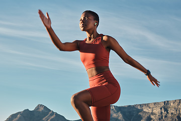 Image showing Black woman runner, mountain and balance in outdoor nature for fitness, health and wellness to start morning. Woman, stretching and exercise by mountains with music, focus and workout in Cape Town