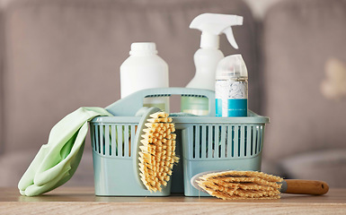 Image showing Product, basket and cleaning with a brush, supplies or detergent on a wooden table surface for housework. Bacteria, living room and empty room with a container of disinfectant in a house or home