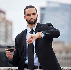 Image showing Businessman, watch and check time in city for schedule, business meeting or street by buildings. Corporate black man, clock and late for finance meeting in metro, frustrated and coffee in cityscape