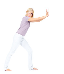 Image showing Portrait, push and mockup with a woman in studio on a white background trying to move advertising or marketing space. Pushing, effort and heavy with an attractive young female moving blank space