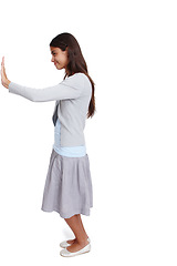 Image showing Push, move and mockup with a woman in studio isolated on a white background moving a poster or billboard. Mock up, effort and pushing with an attractive young female standing alone on blank space