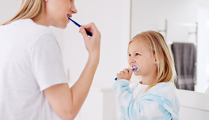 Image showing Development, mother and girl in bathroom with brush for teeth doing bonding, embrace and loving together. Female parent, lady and kid or child brushing teeth, dental hygiene and child growth at home.