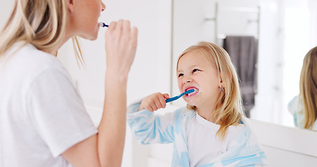 Image showing Development, mother and girl in bathroom with brush for teeth doing bonding, embrace and loving together. Female parent, lady and kid or child brushing teeth, dental hygiene and child growth at home.
