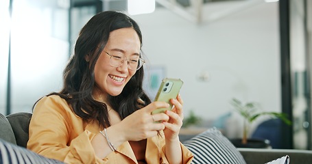 Image showing Phone communication, talking and asian woman at home on a sofa with a online conversation. Phone call, speaking and networking of a person on a mobile phone at a living room house on a couch