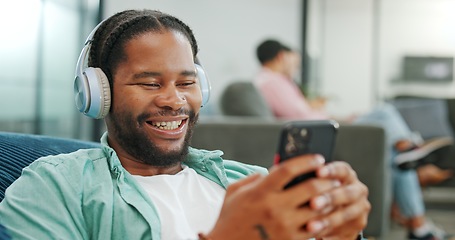 Image showing Laugh, happy and mobile text of a black man typing on social media communication app. Laughing, internet scroll and web meme of a man online on a mobile phone texting and reading a funny joke